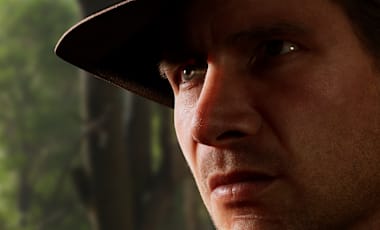 Indy makes a serious face against a backdrop of trees
