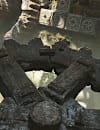 Indy holds a large cog as he solves a massive gear-based puzzle in Sukhothai
