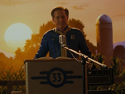 Still from the Fallout TV show. The Ghoul stands in a cobbled-together town.