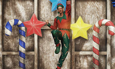 An Appalachian elf jumping in between life-size Plastiform Candy Canes and Plastiform Stars.