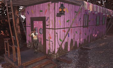 A man standing outside a sippin' station making a heart shape with his hands.