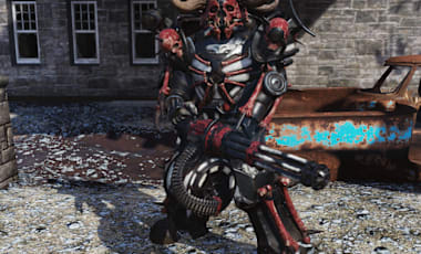 A character in Fallout 76 wearing red and black power armor with a horned helmet, standing on gravel near a rusty car and stone pillars.