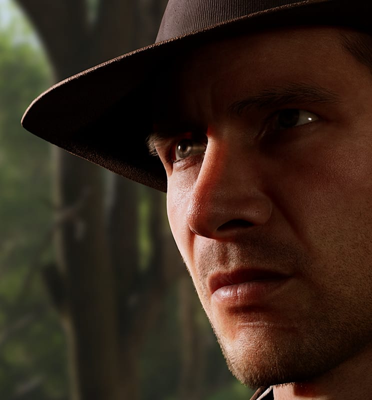 Indy makes a serious face against a backdrop of trees
