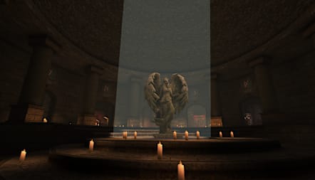 An angelic statue sits beneath a spotlight inside an antechamber.