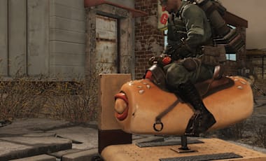 A character riding a kid's arcade ride that looks like a pepperoni roll.