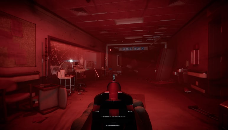 A modern-day hallway is bathed in red light.