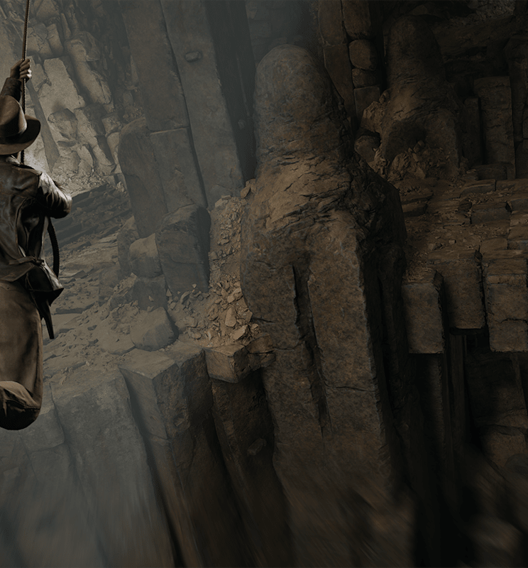 Indy swings across a massive, rocky chasm with his whip
