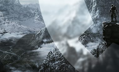 The Dragonborn stands on a cliff overlooking a vast, snowy mountainous landscape. A winding river snakes through the valley below, and grey clouds hover above. A faint Bethesda Game Studio Gear Logo is subtly integrated into the foreground.