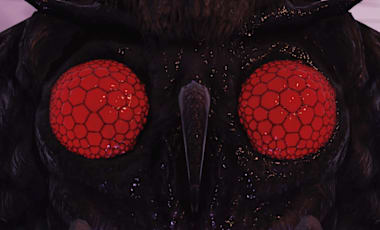 Closeup of a Mothman with its large, red eyes staring right at the viewer.