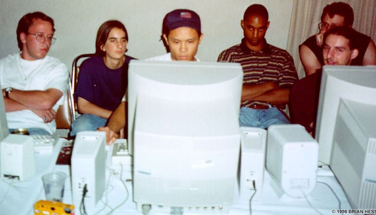 Fans huddle around a monitor at the first-ever QuakeCon