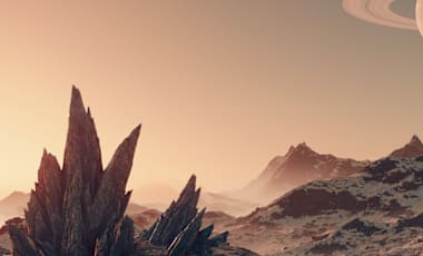 The view of a ringed planet in the sky from the surface of a rocky planet.