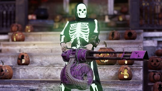 A player character in a glowing skeleton costume wields a large machine gun.