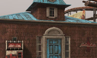 A small factory building with light blue trim and matching door.