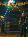 Two player characters fire upon a Vertibird underneath a "Happy Halloween" banner.