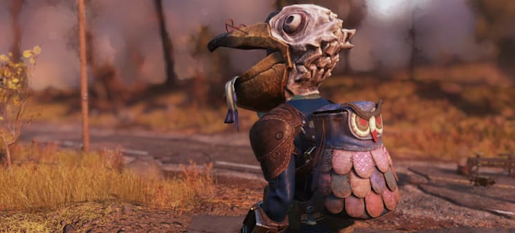 A character wearing a whimsical pelican mask and a colorful, scaled Owl backpack sits on a path surrounded by autumn foliage