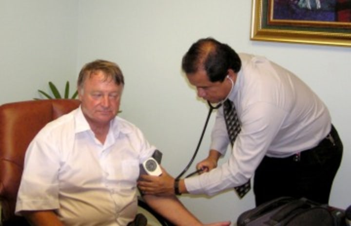 Doctor checking blood pressure