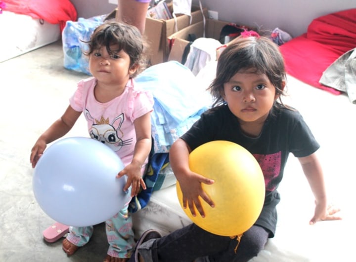 two kids with ballons