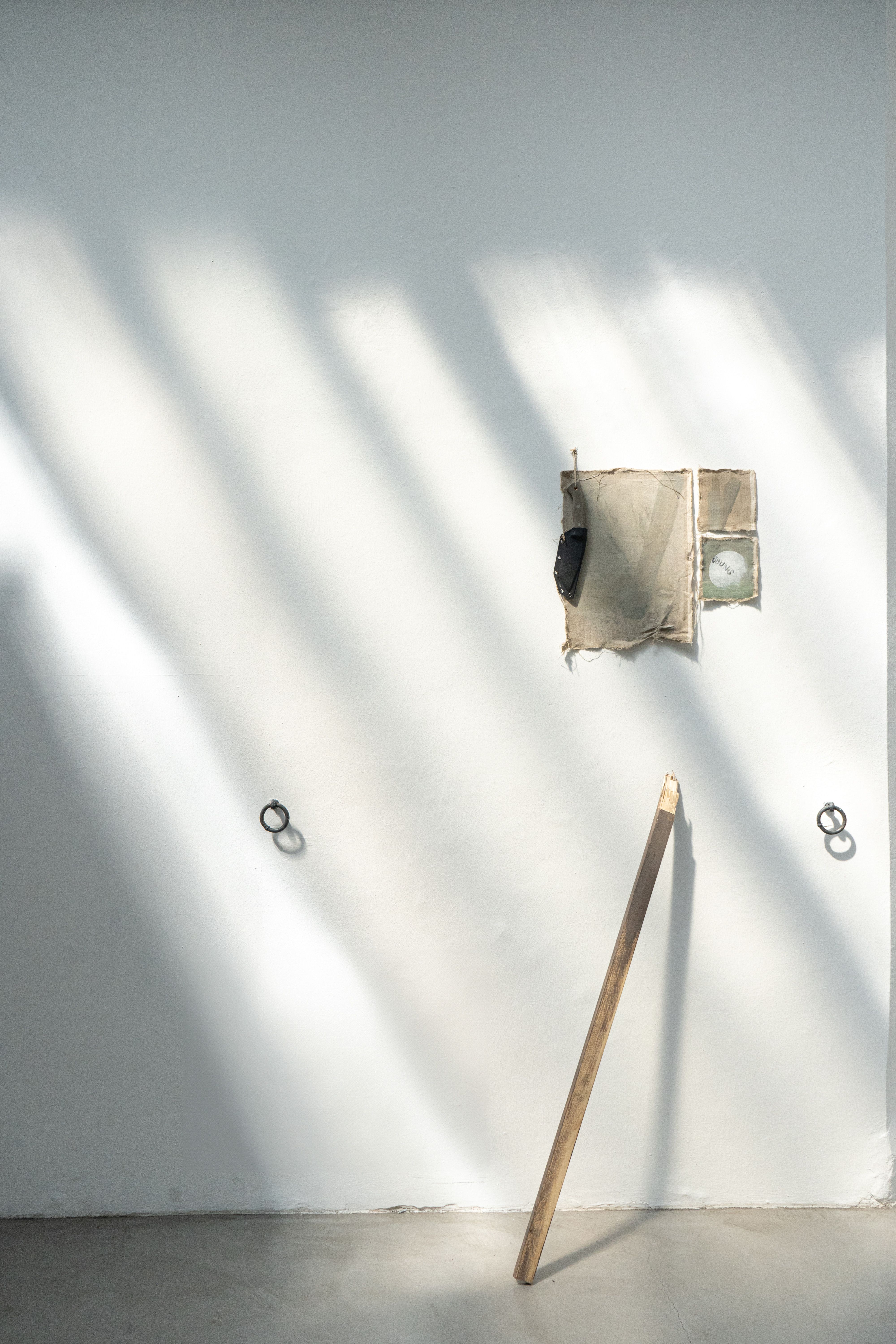 Installation with wooden stick and knife