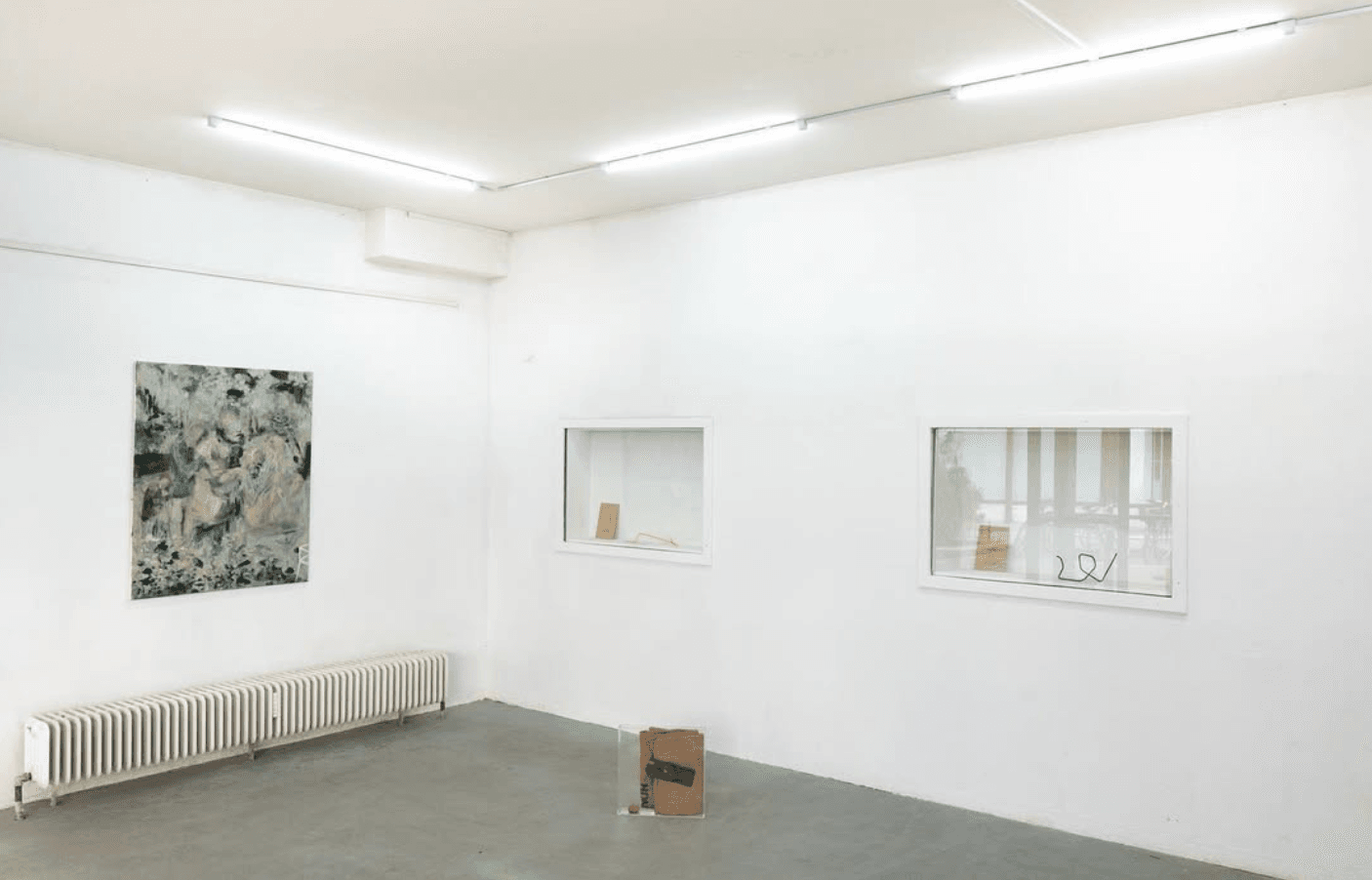 Exhibition view with objects and painting. 
