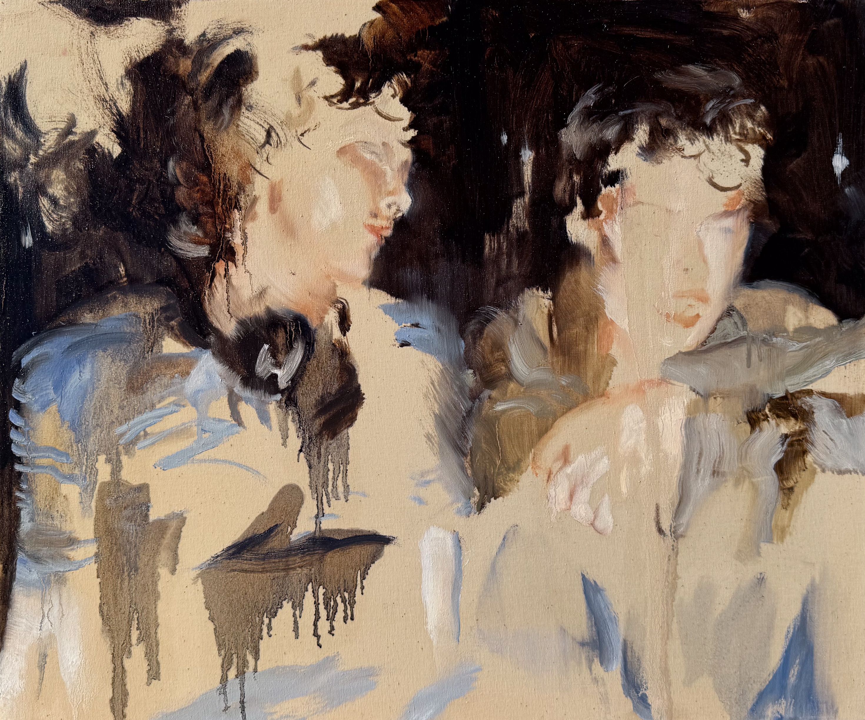 two young guys, sitting in front of a dark wall inside a divebar. 