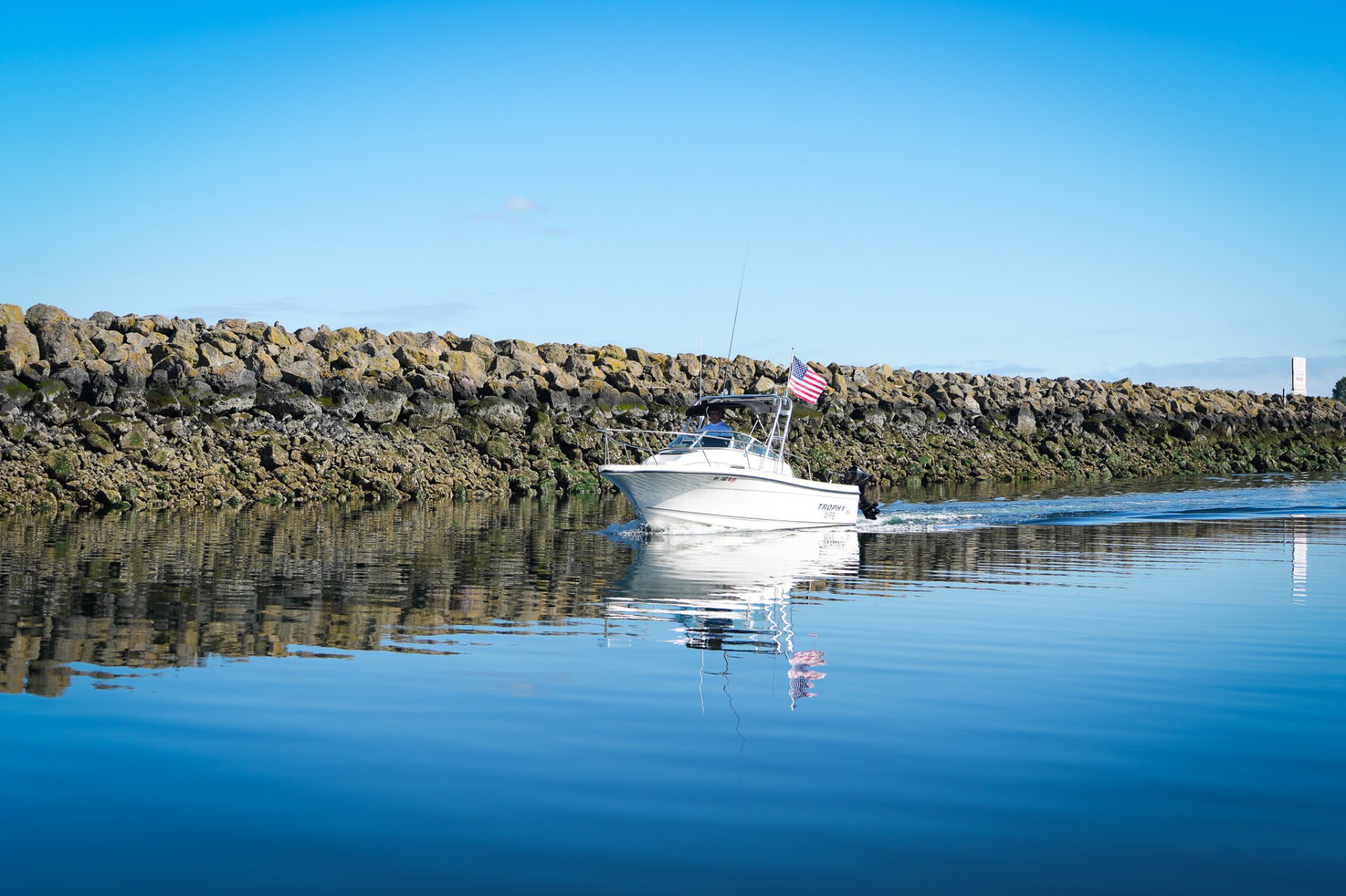 Clearing the breakwater — the open Sound ahead, the marina fading behind