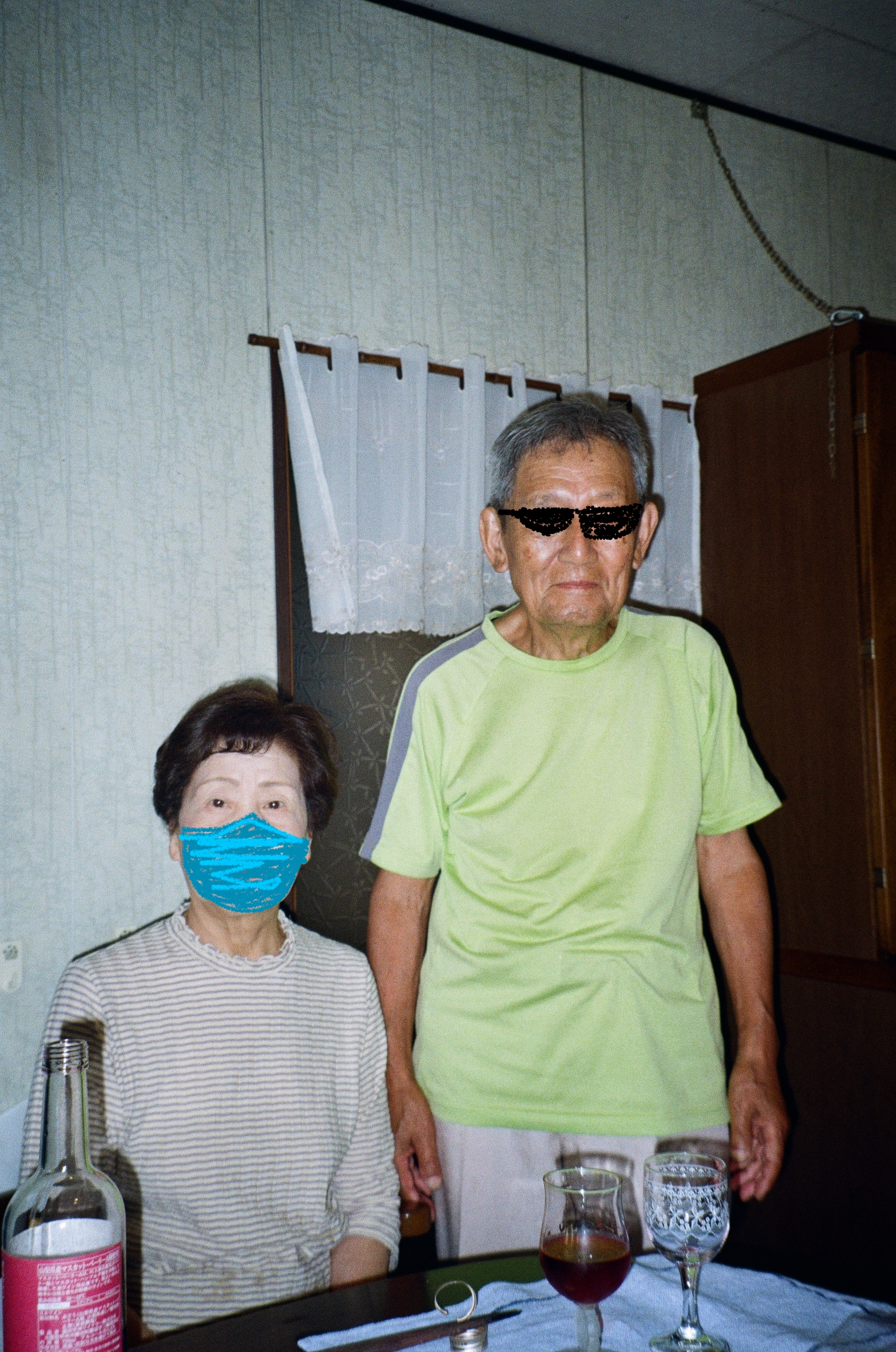 Photo of a woman seated next to a man indoors, by the dining table