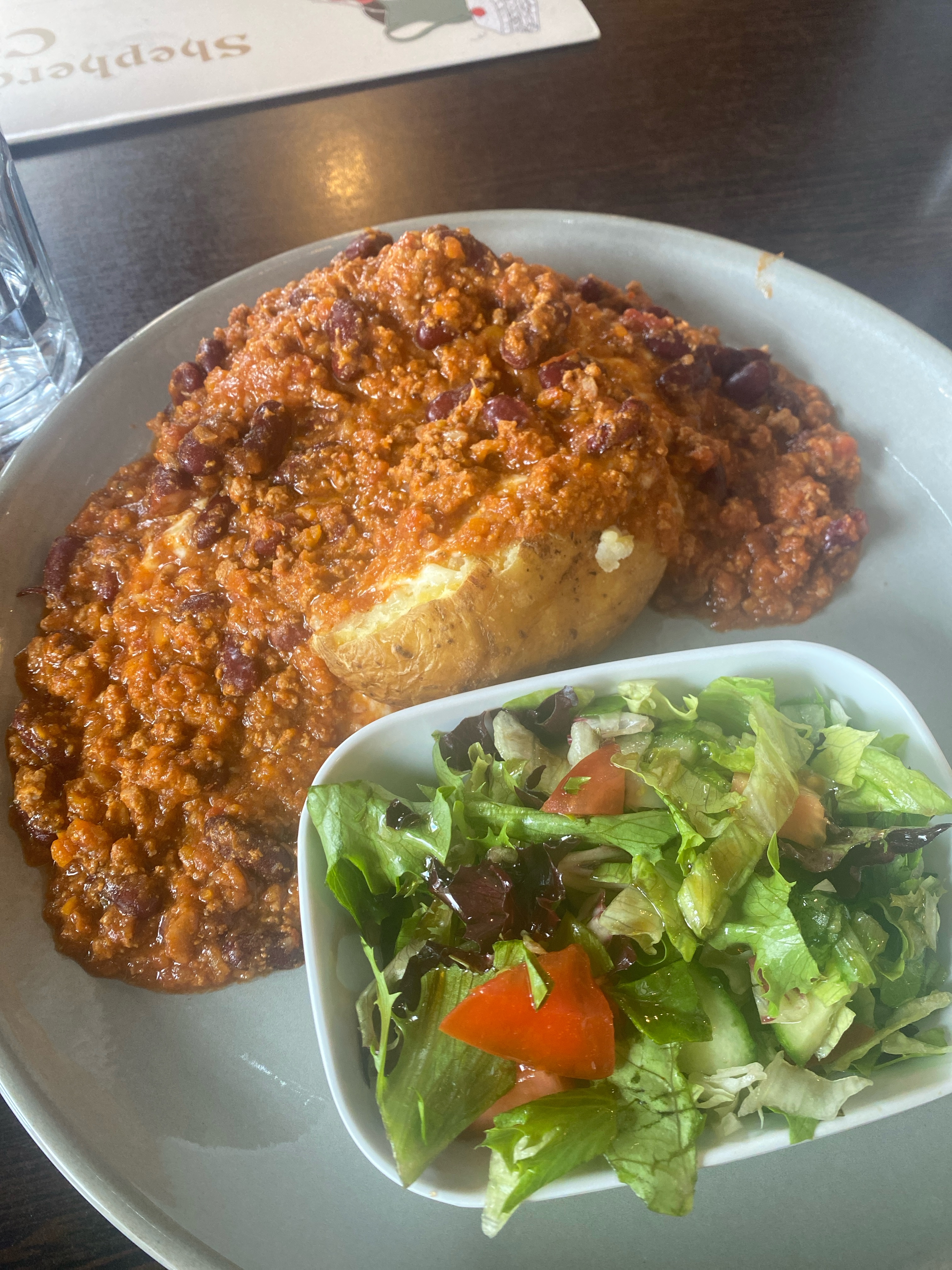 Chilli con carne baked potato with salad on the side