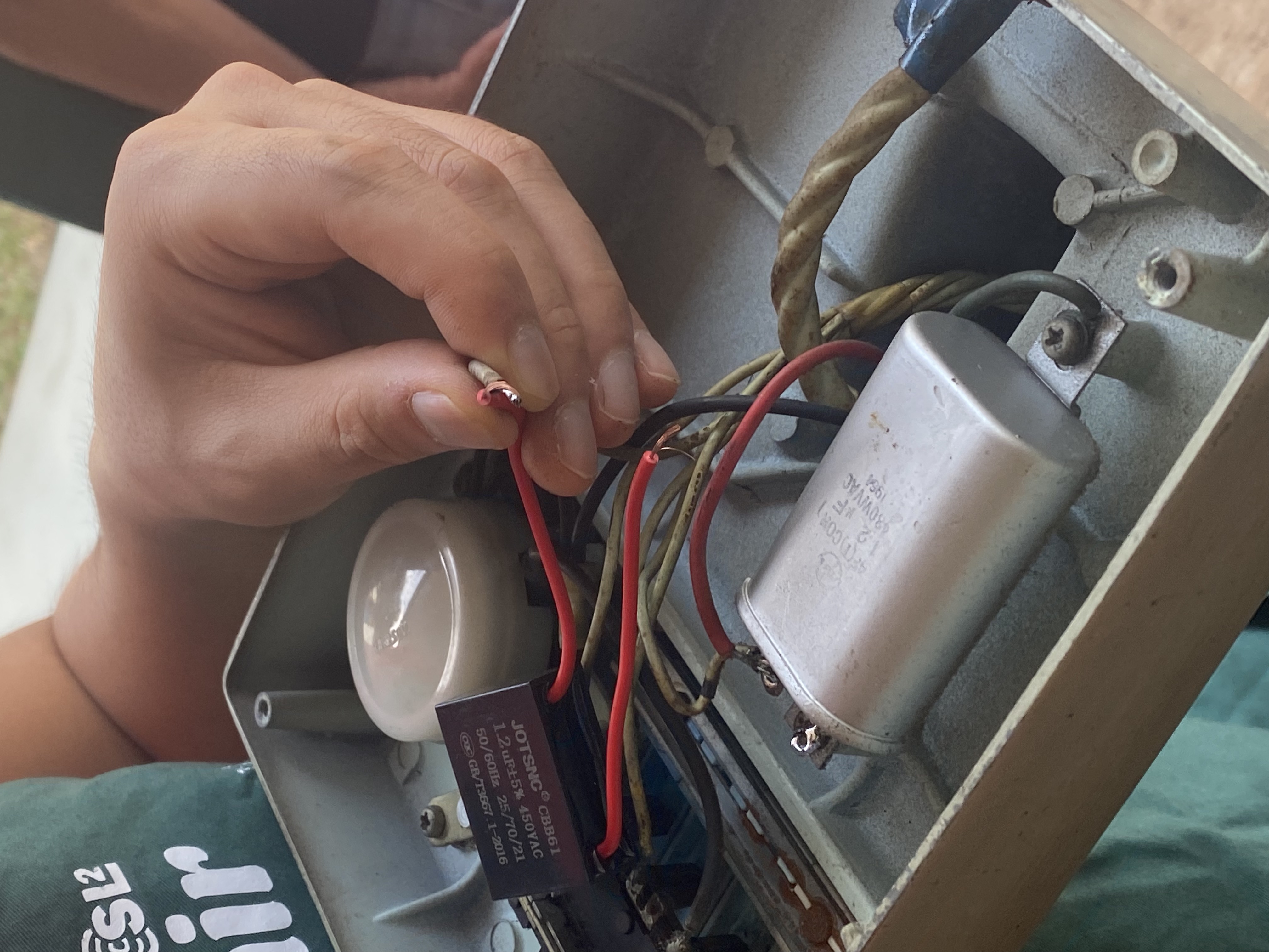 Fan with its base open and wiring exposed