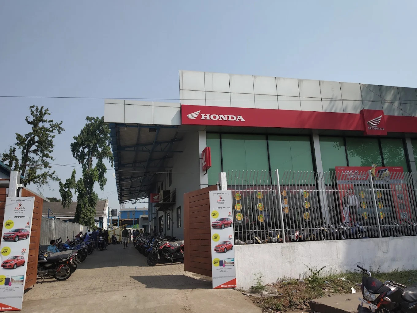 Exterior view of modern Honda dealership with showroom glass facade