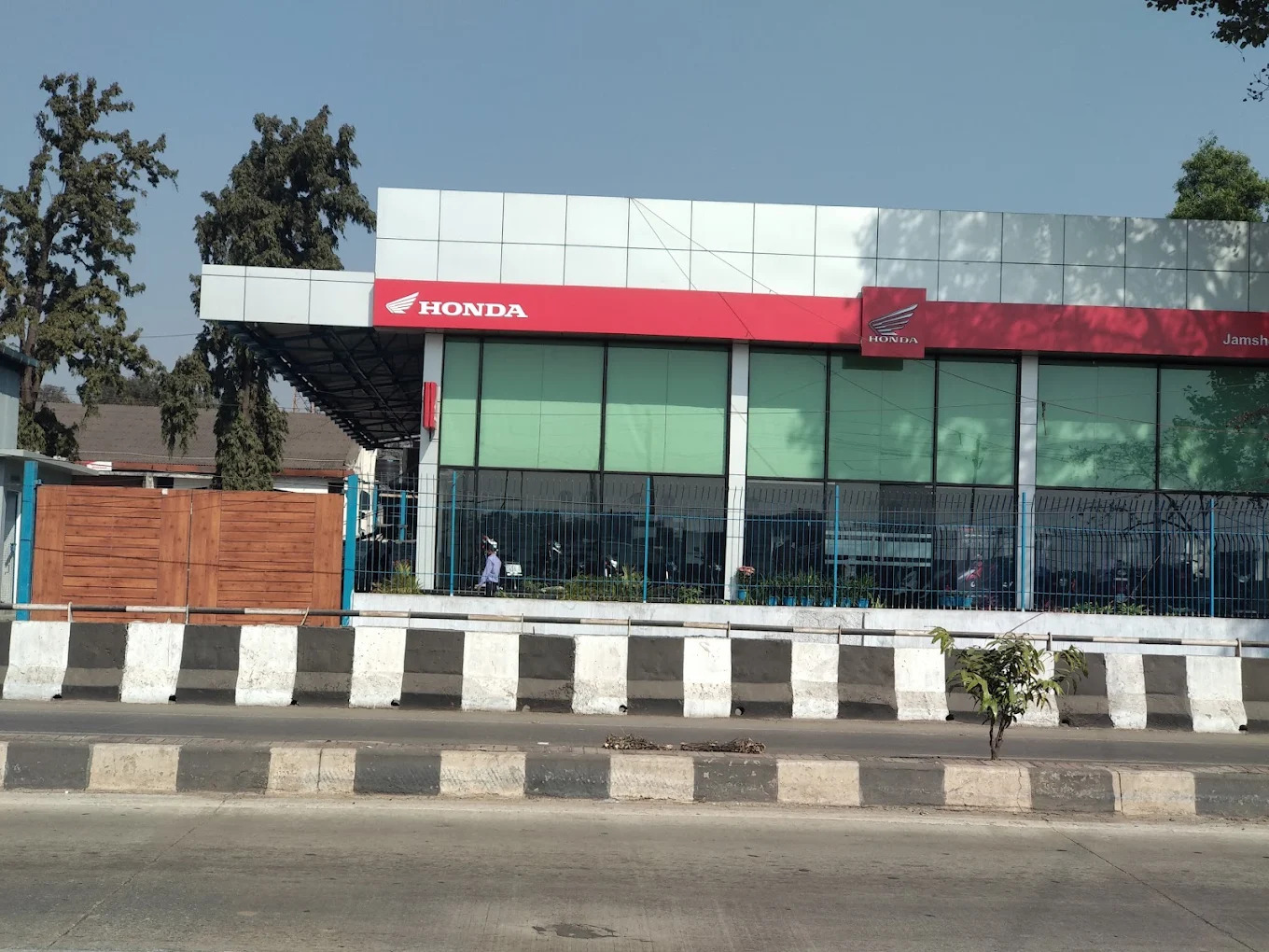 Main entrance facade of Honda dealership with prominent branding