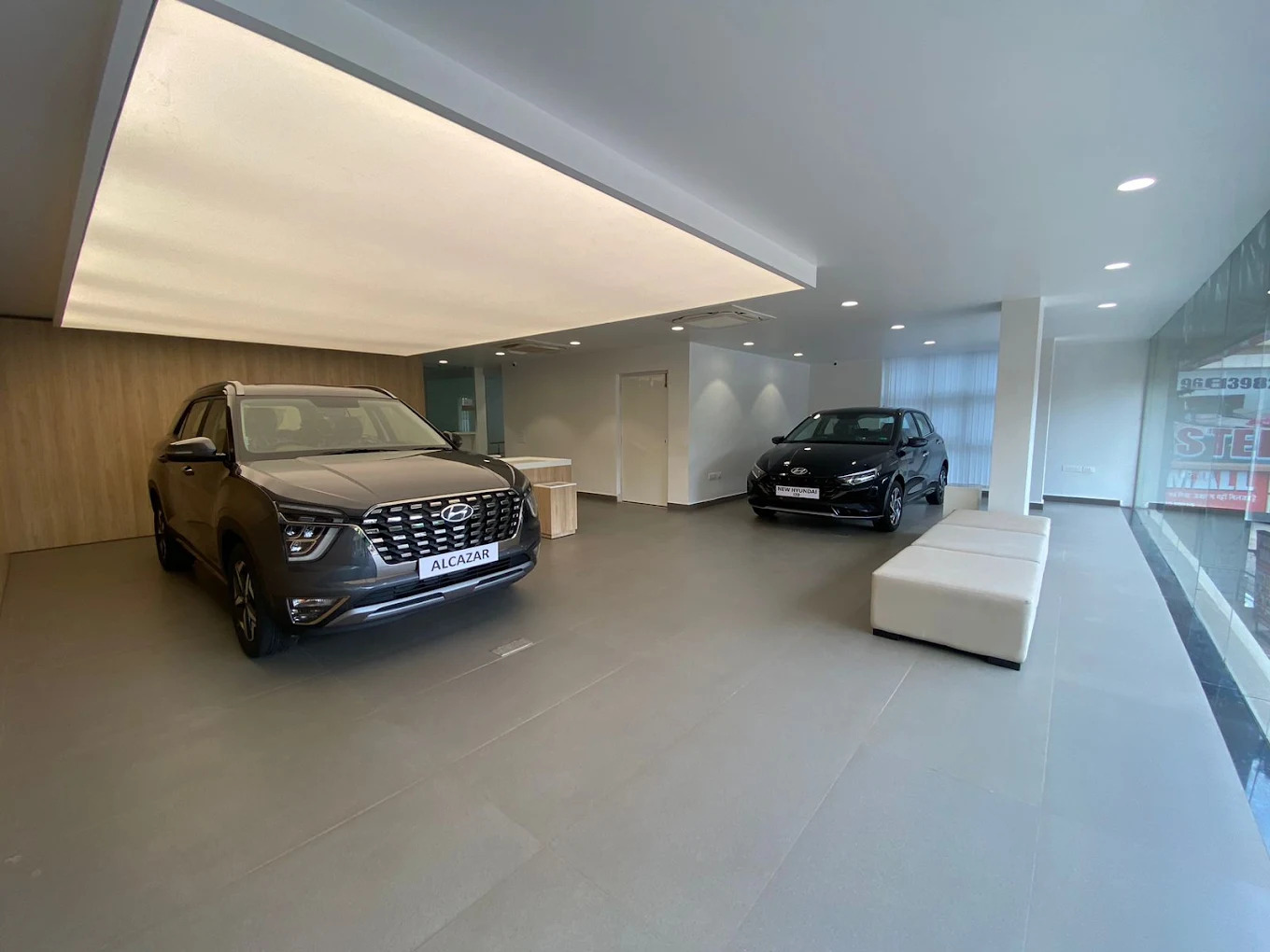 Inside Hyundai showroom featuring vehicle displays and reception desks