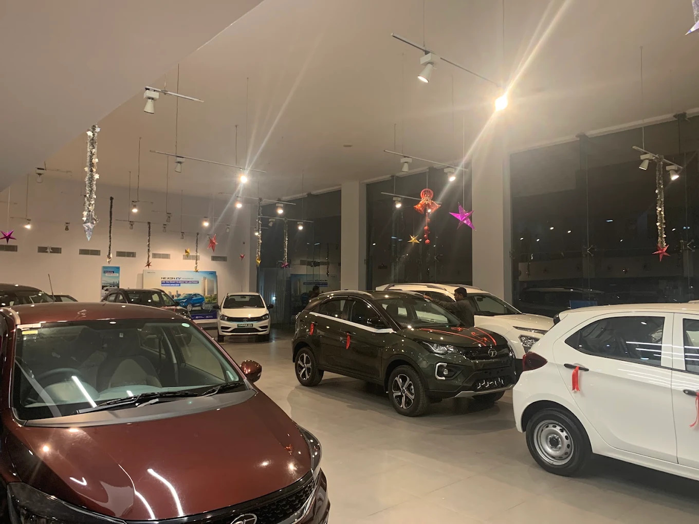 Inside Tata Motors showroom displaying cars and EV charging displays