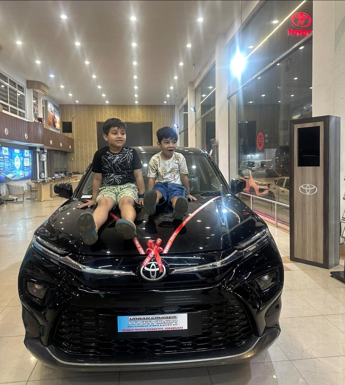 Interior showroom floor of Toyota dealership with vehicles on polished floor