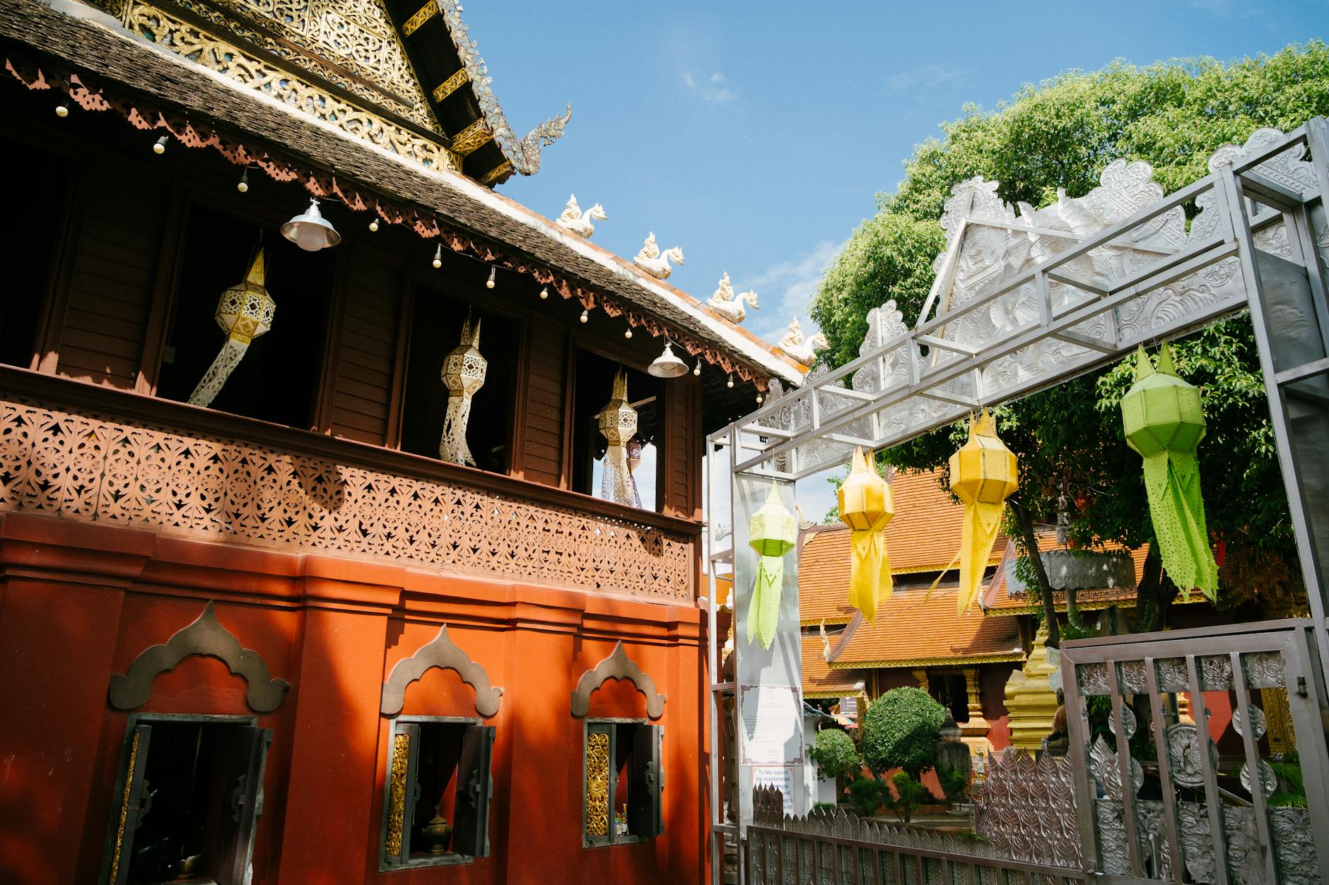 Stunning view of colorful lanterns and ornate temple architecture in Chiang Mai, Thailand.