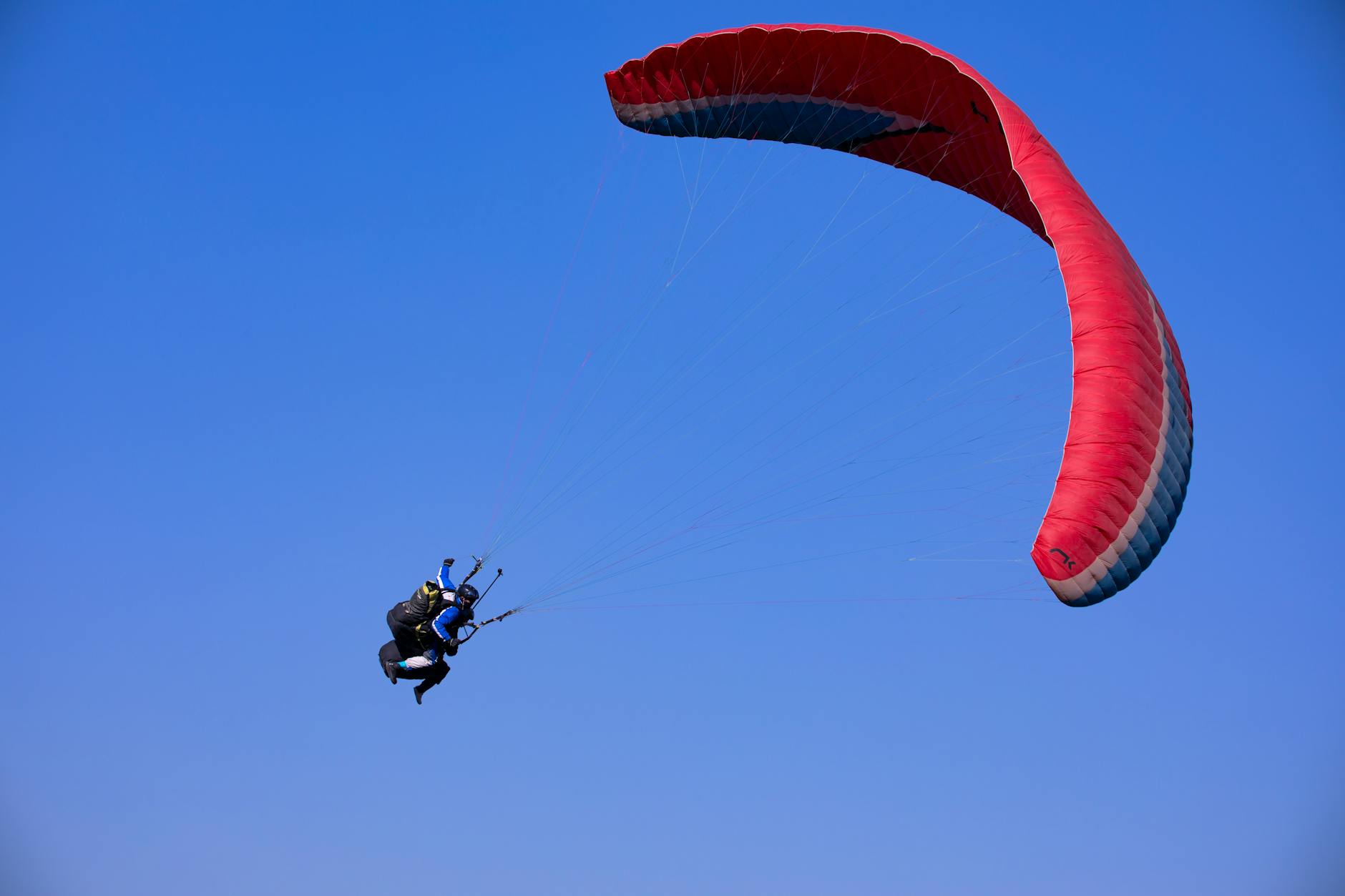 Exciting paragliding experience in Danyang-gun, South Korea under clear blue skies.