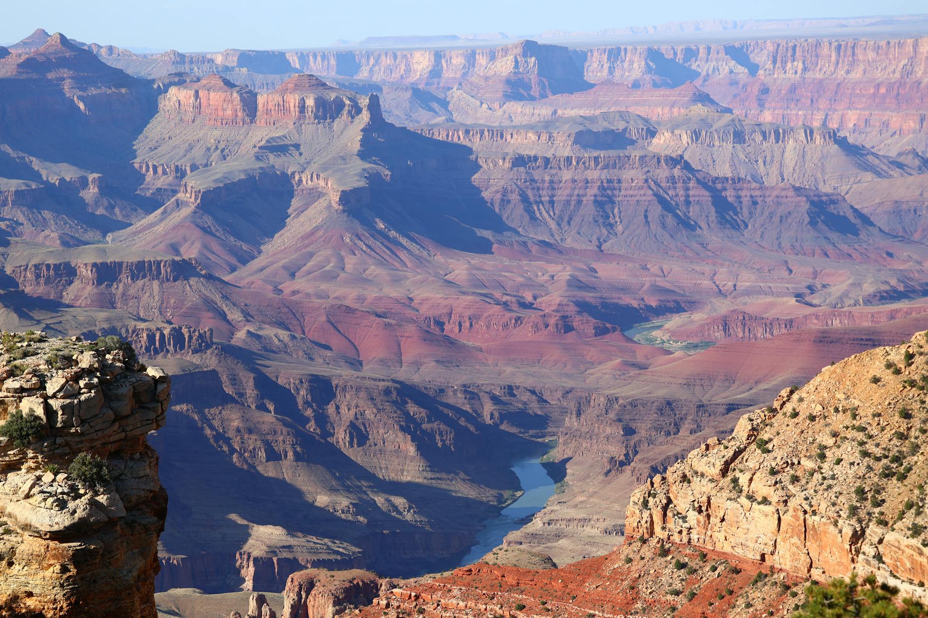 Breathtaking panoramic view of the Grand Canyon, showcasing its vast layers and vibrant colors.