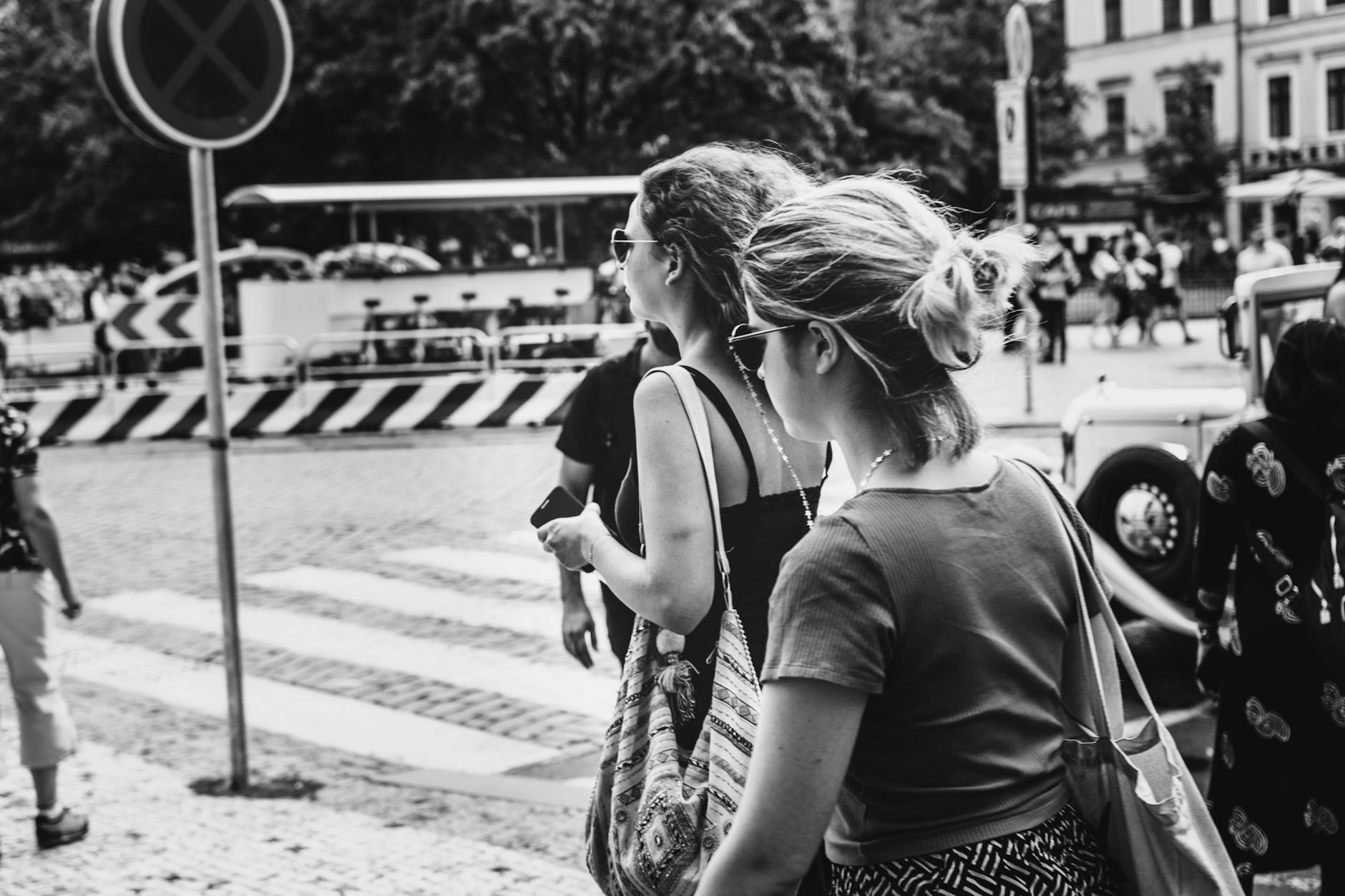 Women walking in Prague, a city scene captured in black and white photography.