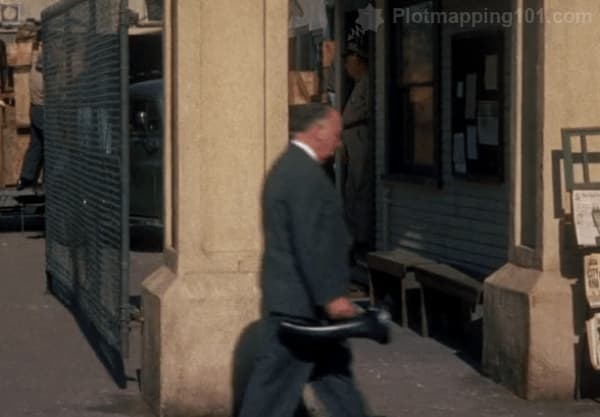 Alfred Hitchcock walks by in one of his cameos, from left to right.