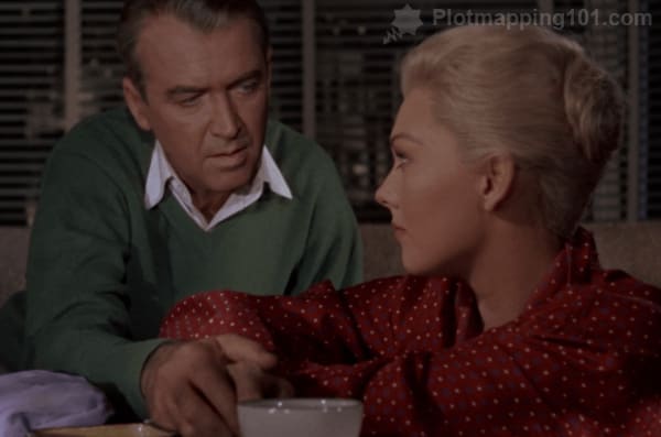 Scottie and Madeleine reach for the cup at the same time, and their hands touch.