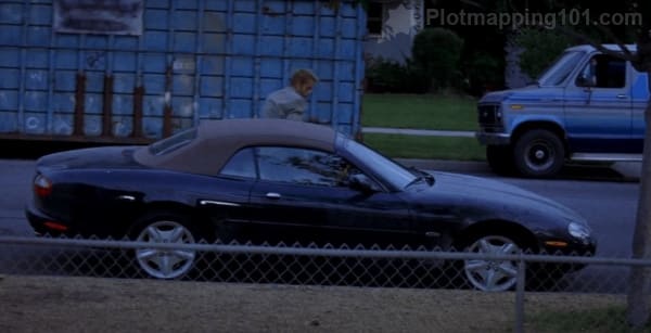 Leonard parks his car in front of Natalie's house.