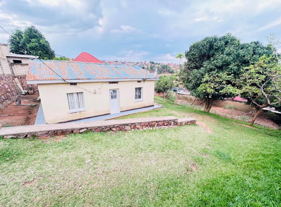 P017 Prime plot for sale in Kabeza featuring an existing old house