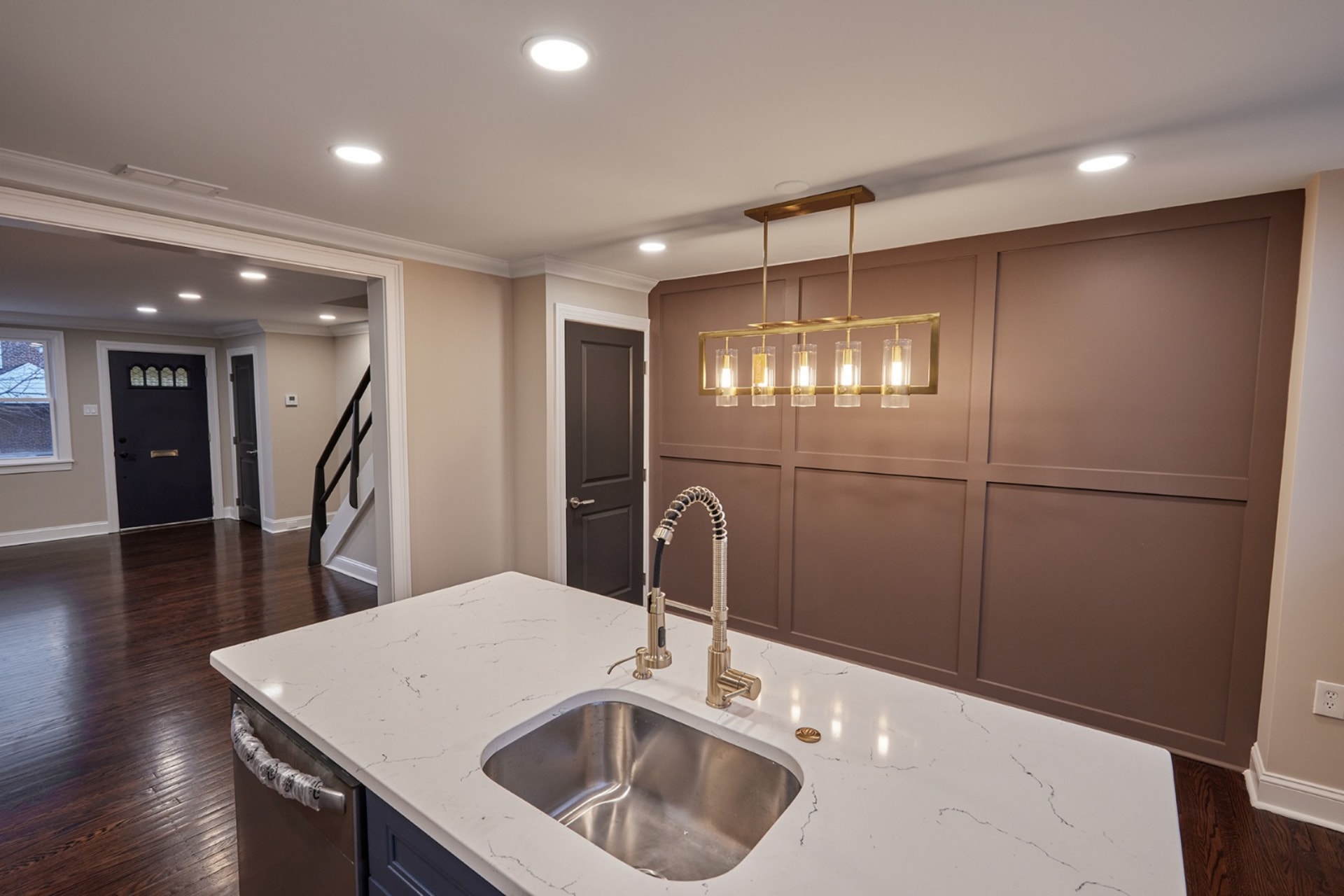 Custom paneled accent wall with brass pendant lighting, AZ Home Remodeling
