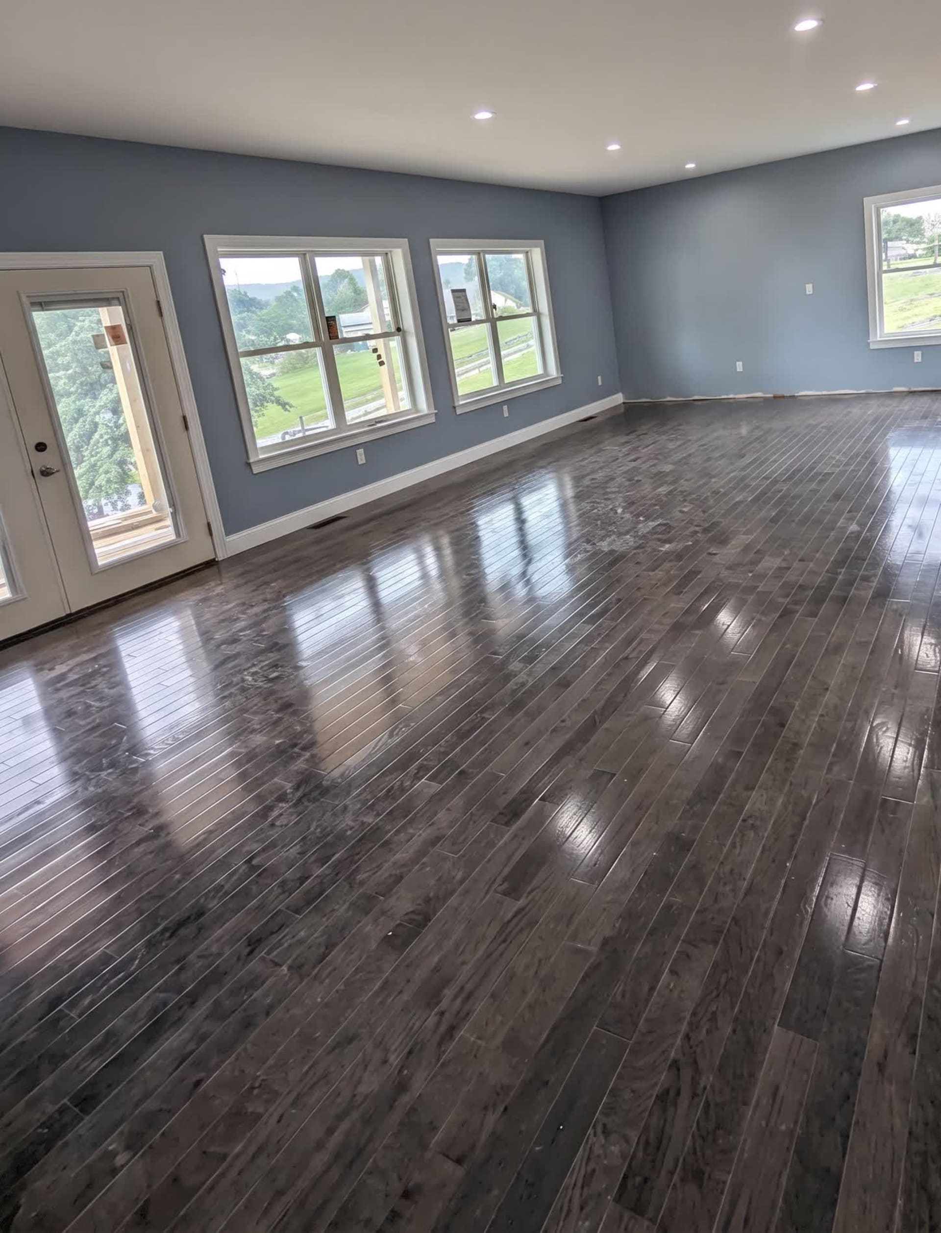 Newly built room addition with hardwood floor and expansive windows, AZ Home Remodeling