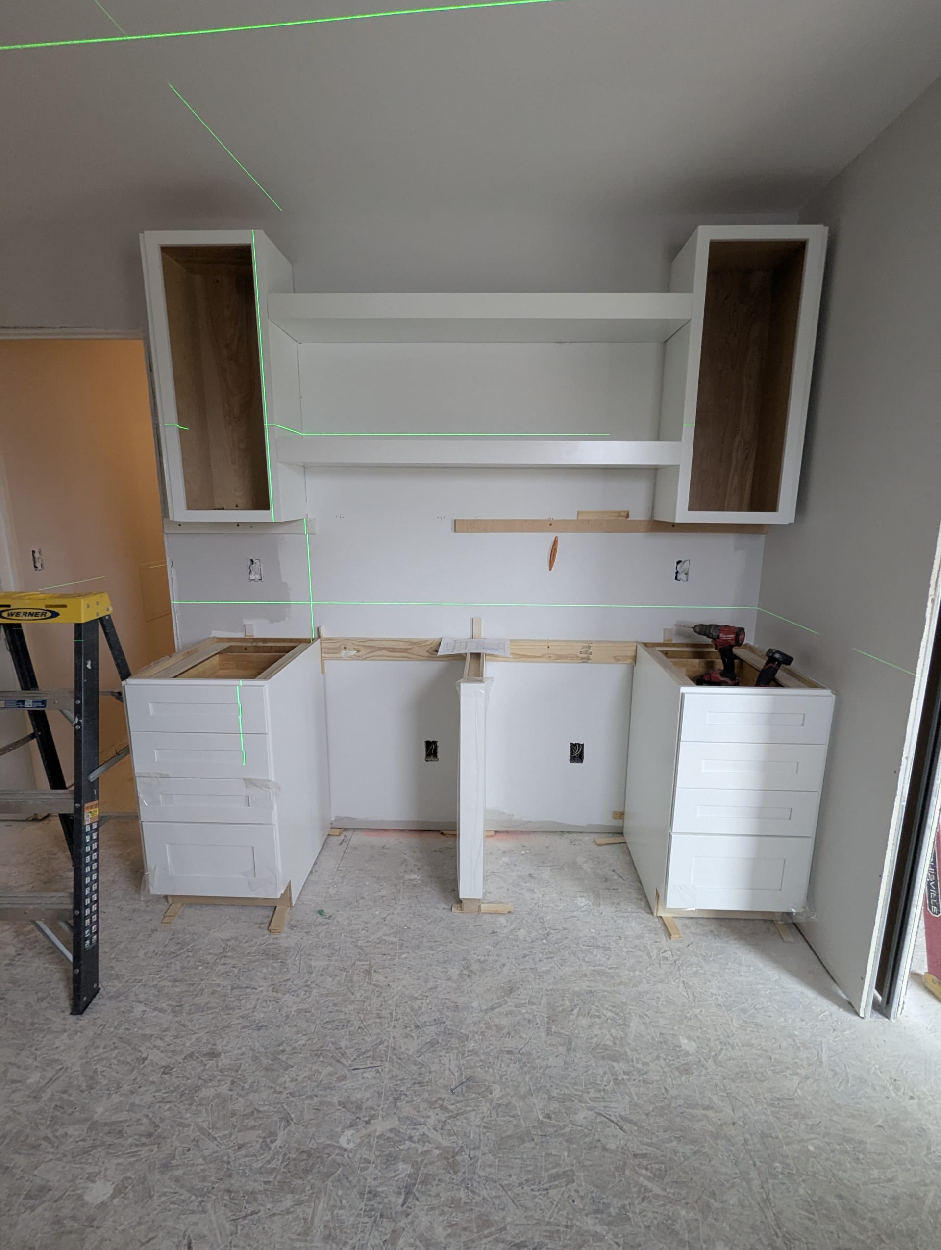 Wet bar cabinets being installed, in-progress shot of the build