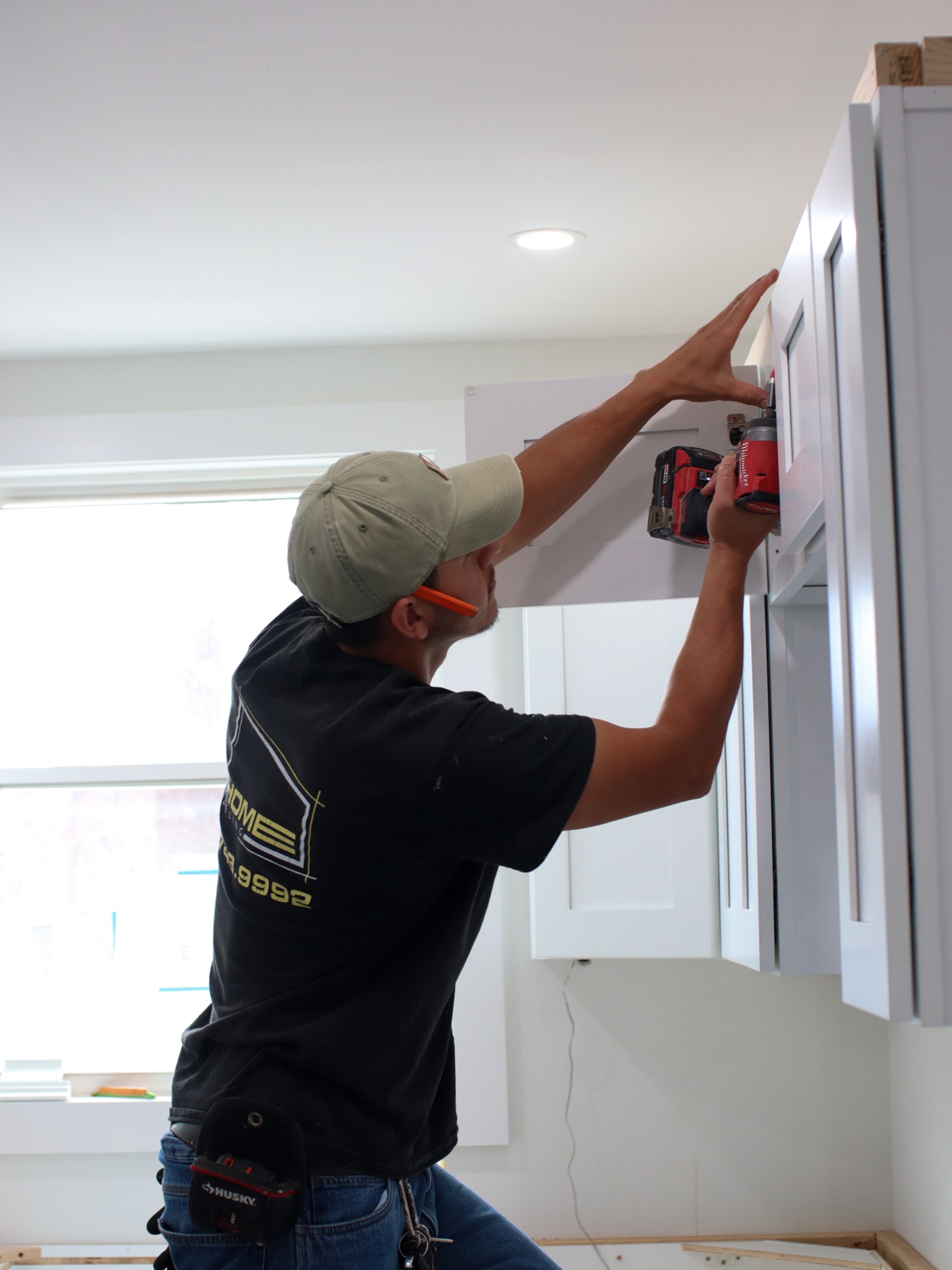 Kitchen remodel in progress, appliance panel being installed