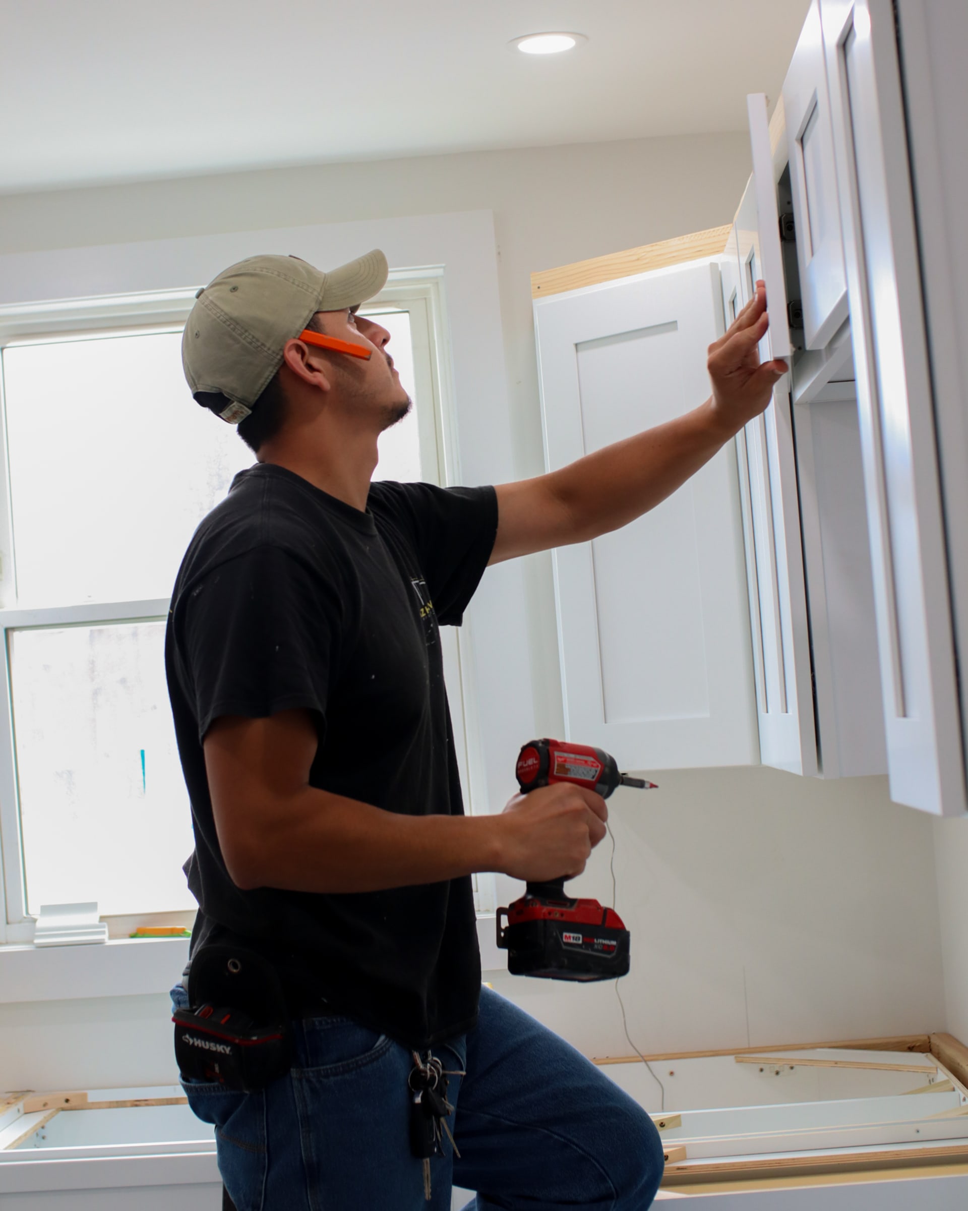 Victor Martinez, owner of AZ Home Remodeling, installing cabinetry on a South Jersey job site