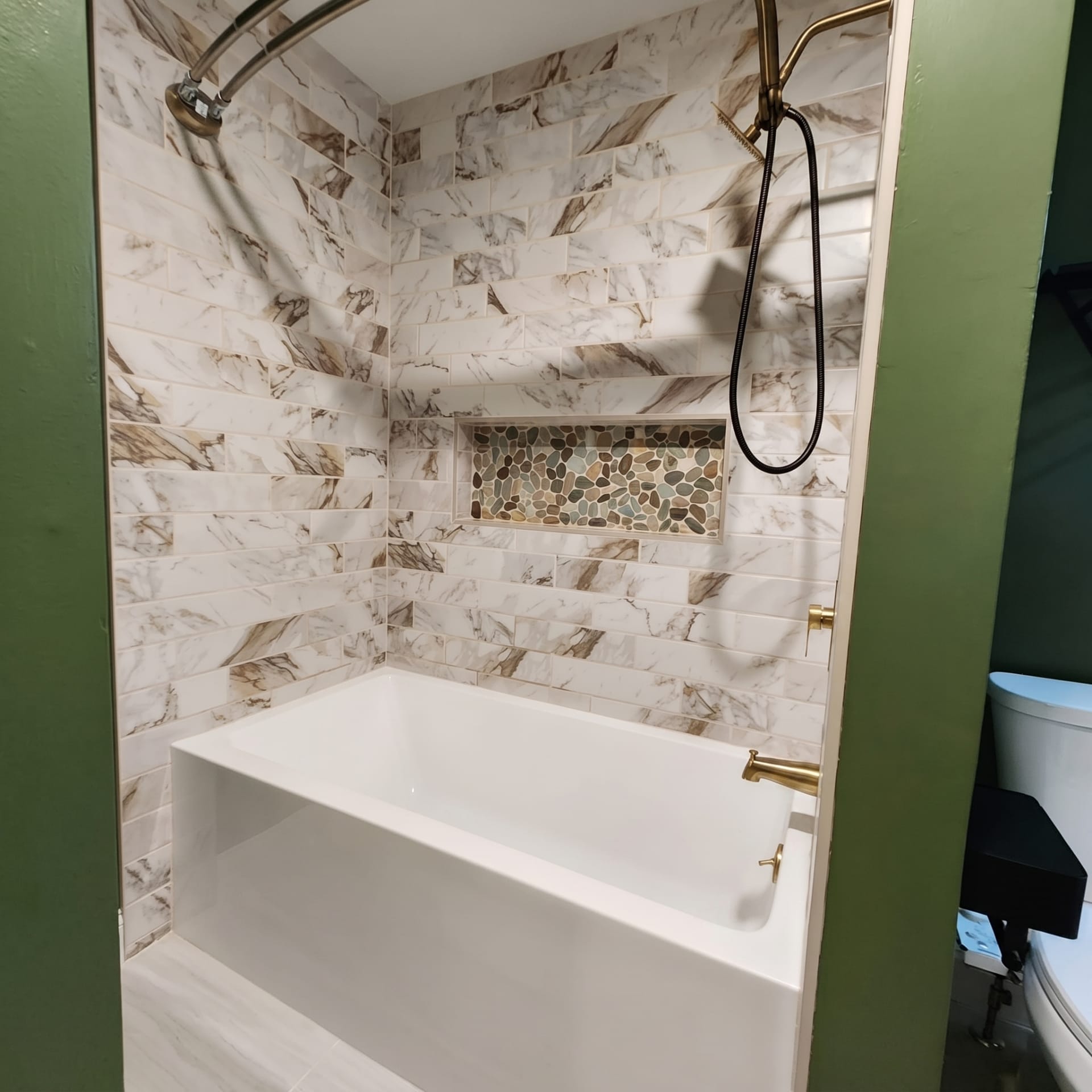 Subway tile tub surround with a pebble-tile niche, AZ Home Remodeling