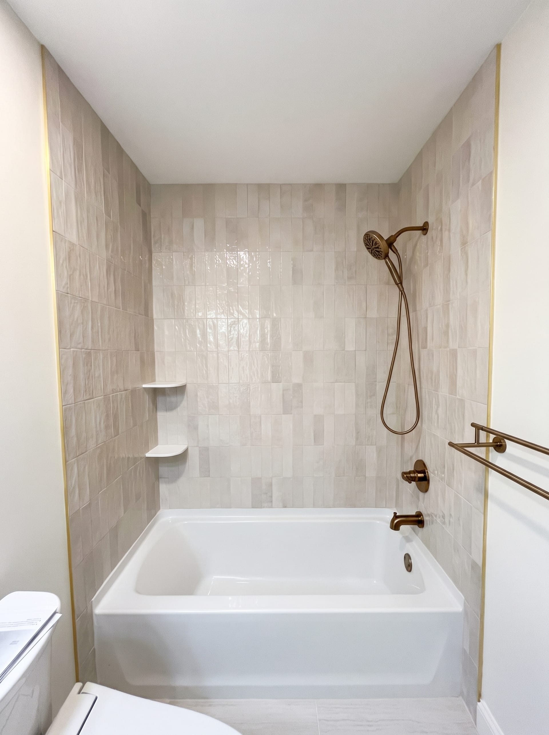 Tan tile tub surround with brass fixtures, AZ Home Remodeling