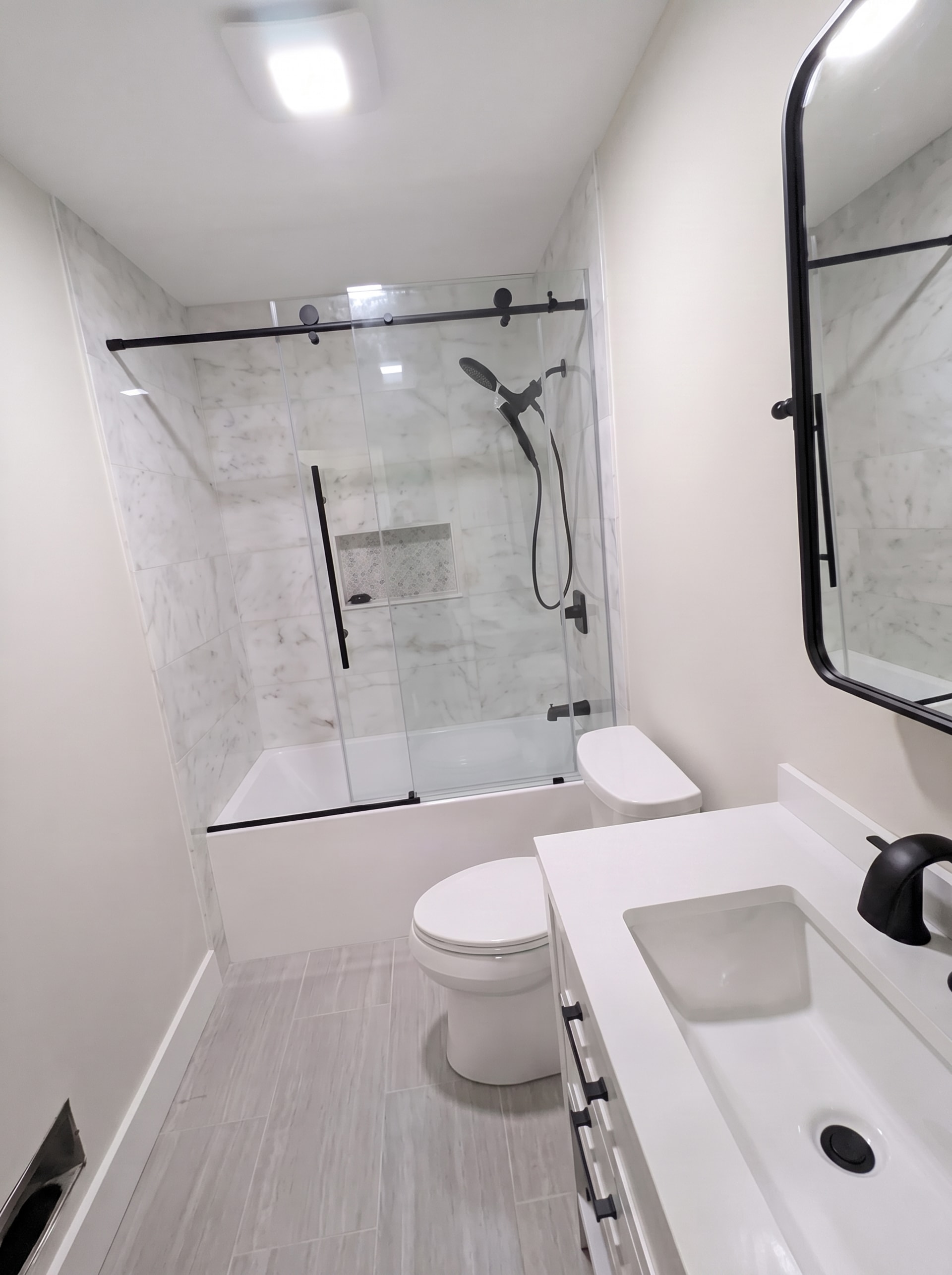 Tub and shower combo with black fixtures, AZ Home Remodeling