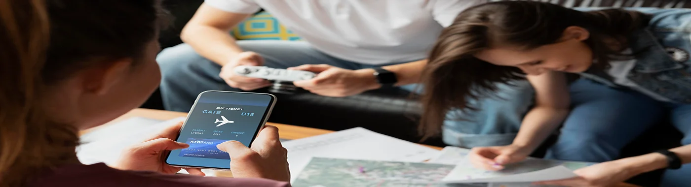 Group of travelers planning a trip with flight tickets and phone showing boarding details, representing Southwest Airlines group flight bookings